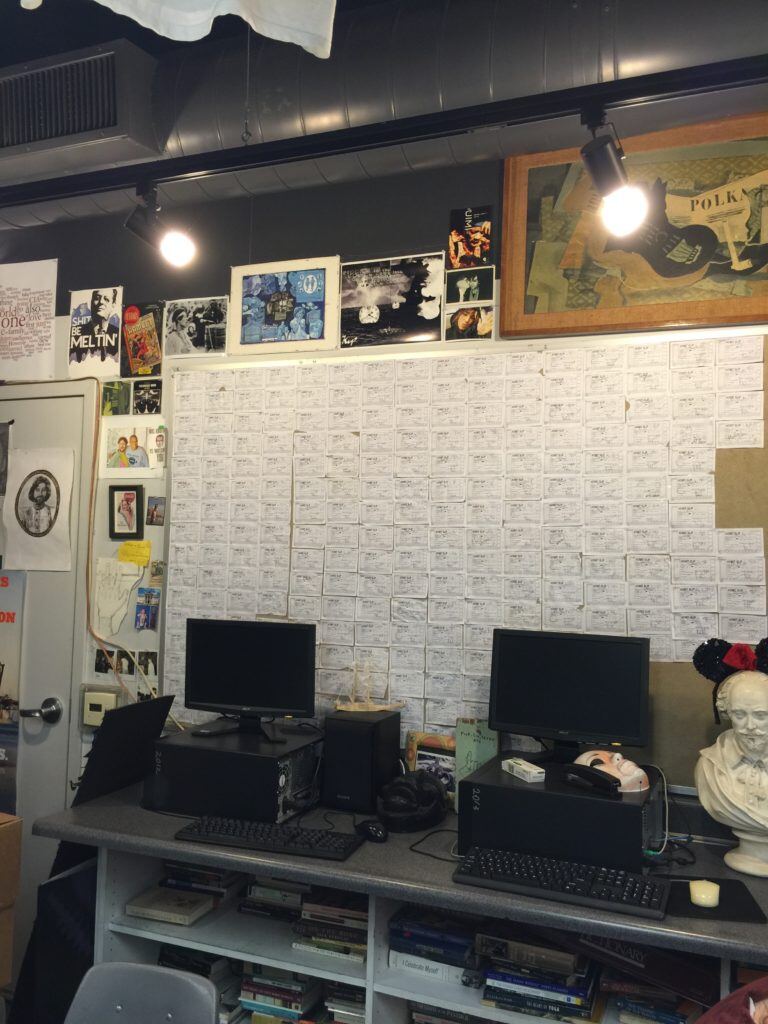 Bryan's classroom maker space with a wall of index cards, PCs and framed art