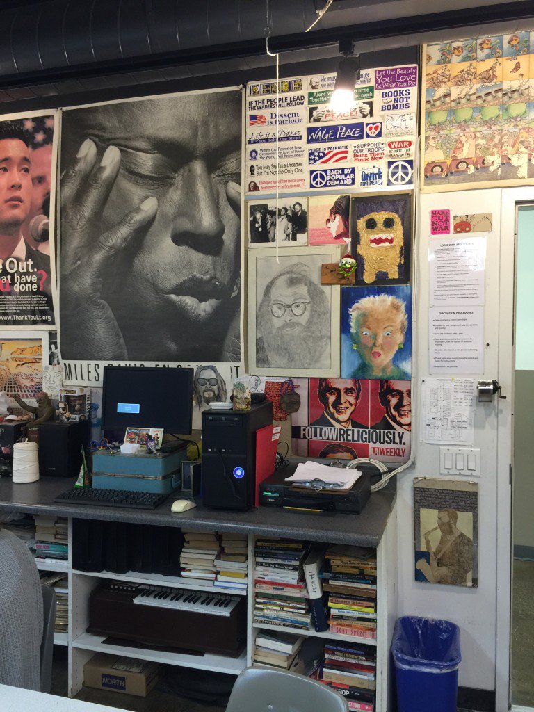 A corner of Bryan's classroom packed with posters, portraits, a keyboard and books